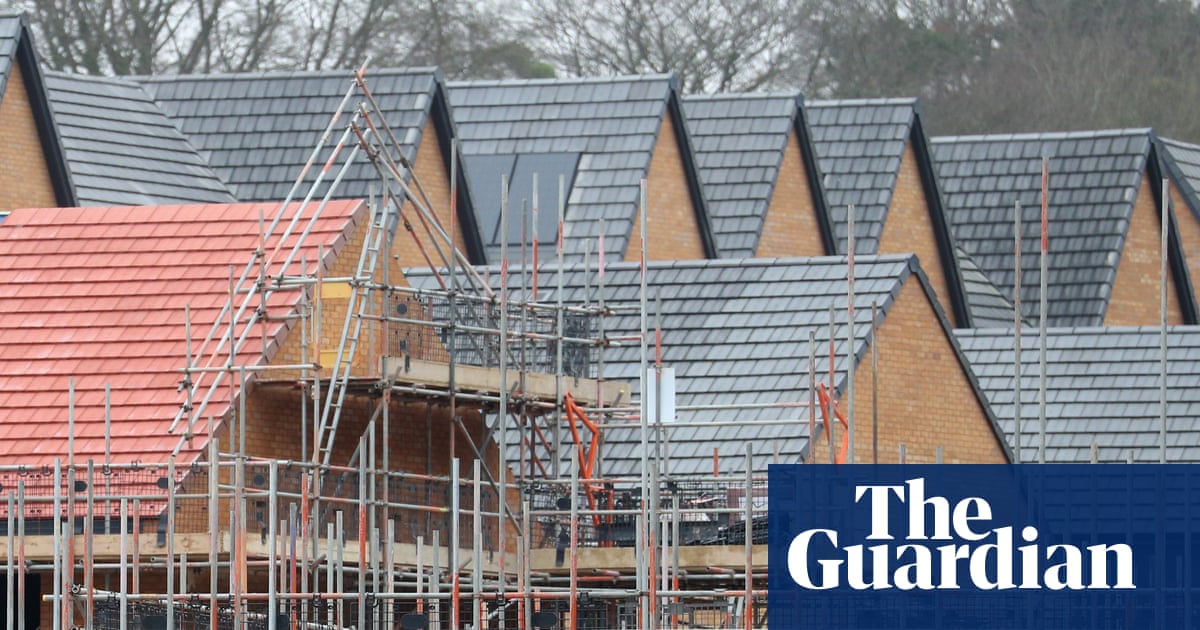 Homes under construction surrounded by scaffolding