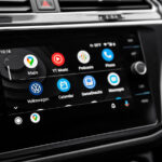 A car's display shows Android Auto.