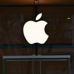 An Apple logo on a storefront.