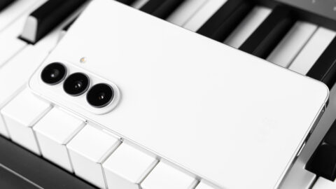 Samsung phone sitting on piano keys.