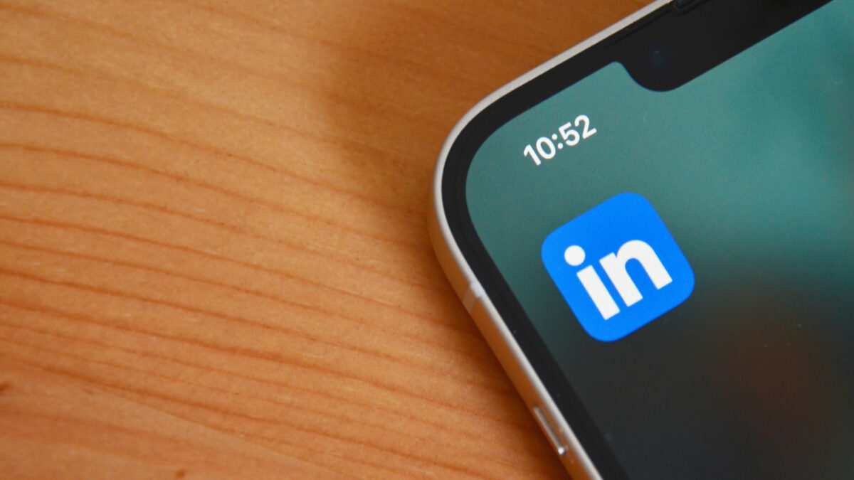 The LinkedIn logo on a phone on a desk.