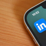 The LinkedIn logo on a phone on a desk.