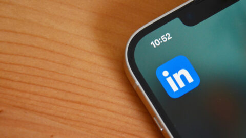 The LinkedIn logo on a phone on a desk.